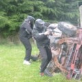 Paintballers hiding behing car