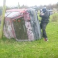 Paintballer hiding behind car